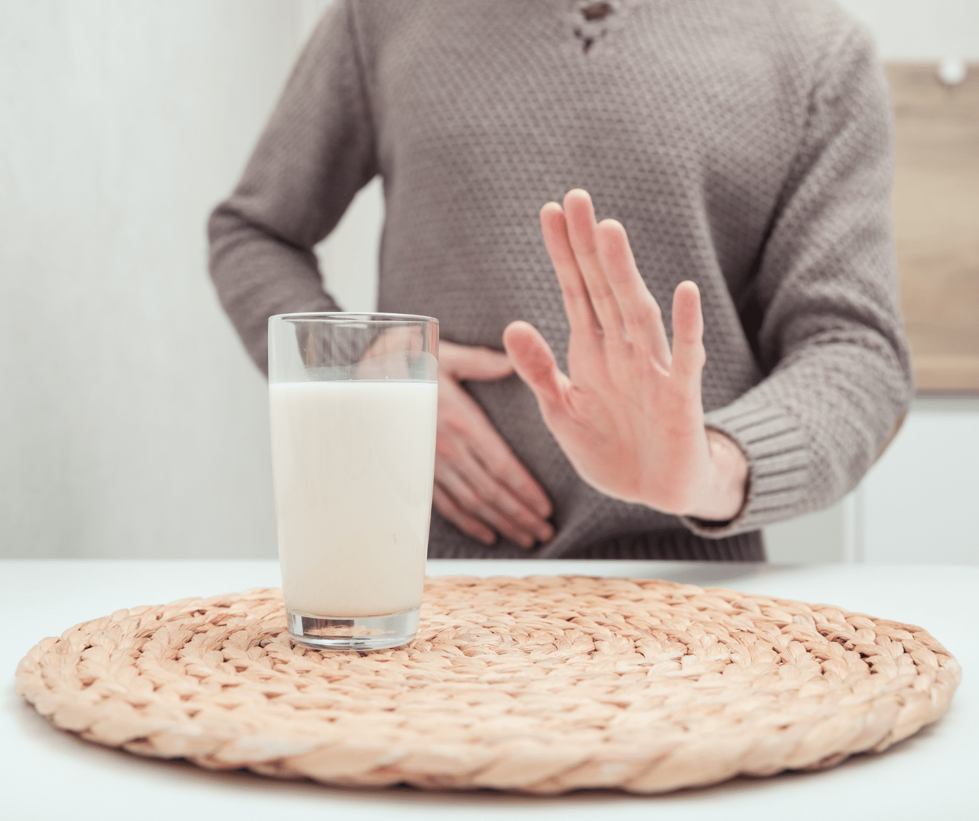 person rejecting dairy with outstreached hand, is milk good for you