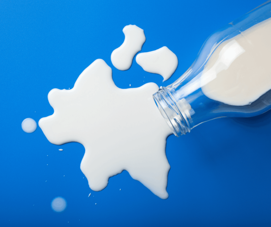 white milk spilled on a blue background